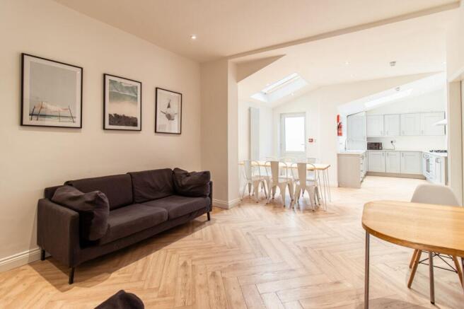 A bright and spacious living area featuring a c...