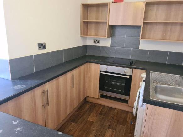 Modern kitchen with wood finish cabinets, integ...