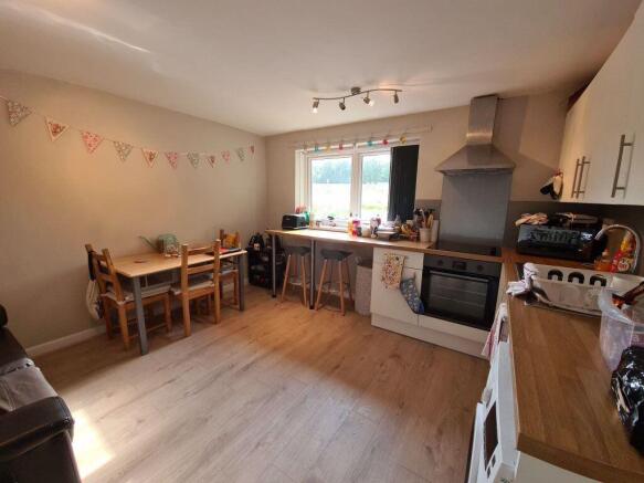 Bright and tidy kitchen featuring modern applia...