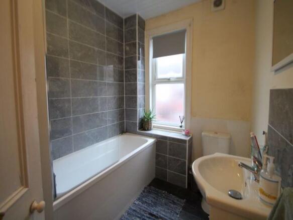 A bright and well-maintained bathroom featuring...