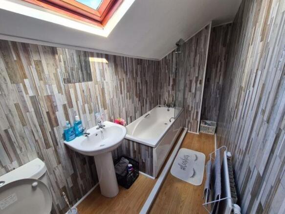 A clean and brightly lit bathroom featuring a b...