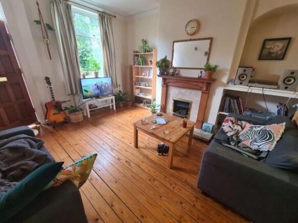 A cozy and welcoming living room featuring natu...