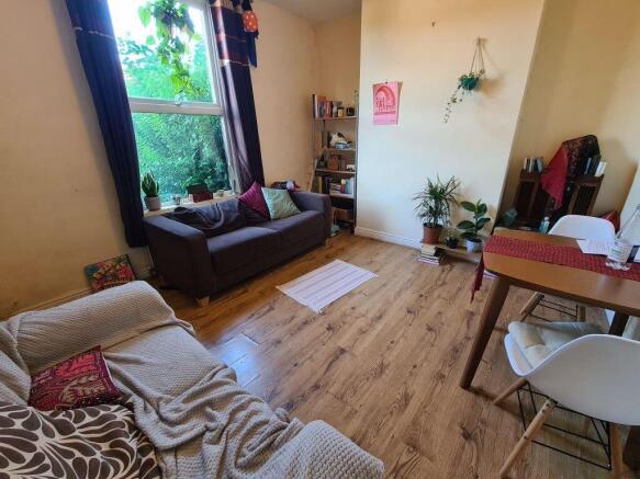 A bright and inviting living room featuring a c...