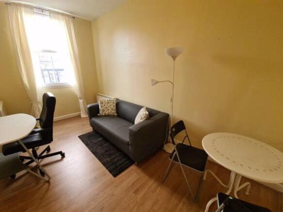 A bright and tidy double bedroom featuring a co...