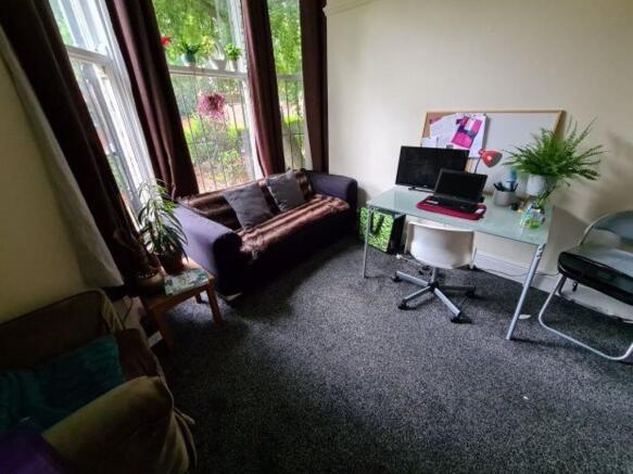 A comfortable living room featuring a sofa, a d...