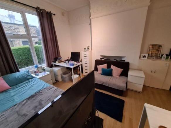 A spacious and well-lit master bedroom featurin...