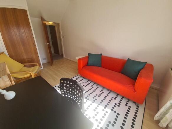 A bright and cozy living room featuring a vibra...