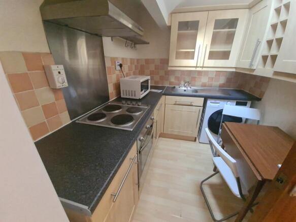 A compact and tidy kitchen featuring modern app...