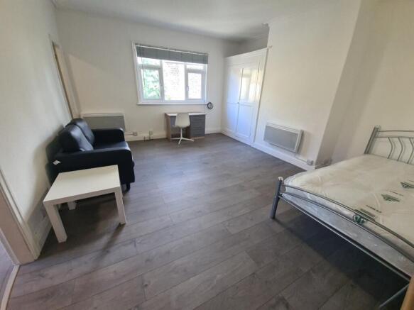 A bright and spacious living room with large wi...