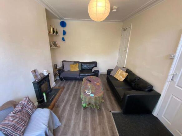 A spacious, well-lit living room featuring mode...