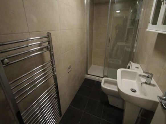 A clean and modern bathroom featuring a large s...