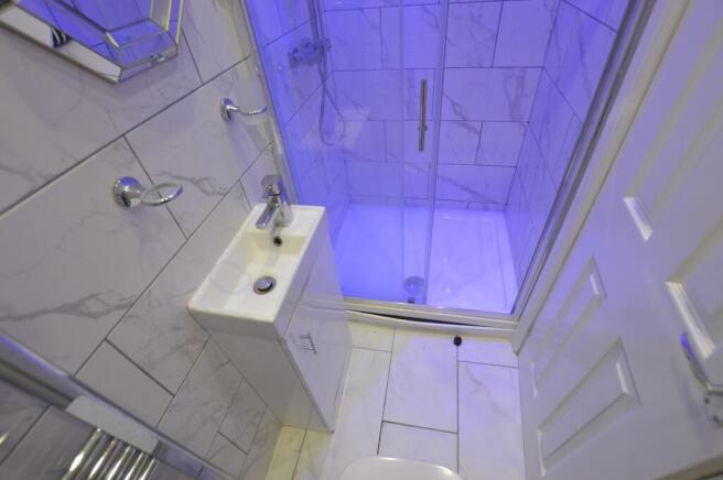Modern bathroom featuring a shower with clear g...