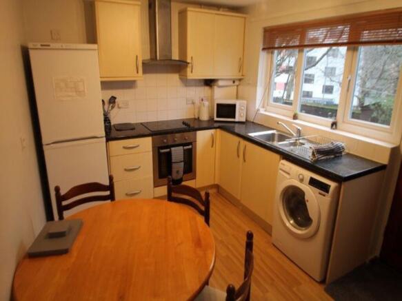 A bright and clean kitchen featuring a large wi...
