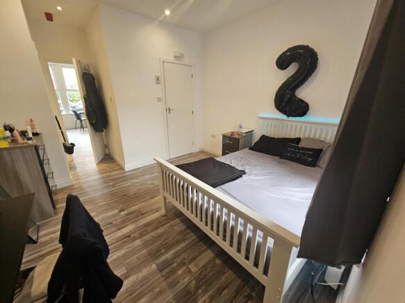 Bright and neatly arranged double bedroom featu...