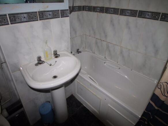 A well-maintained bathroom featuring a bathtub ...