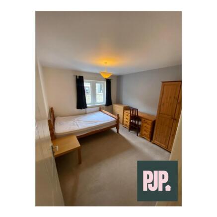 Spacious double bedroom featuring a comfortable...