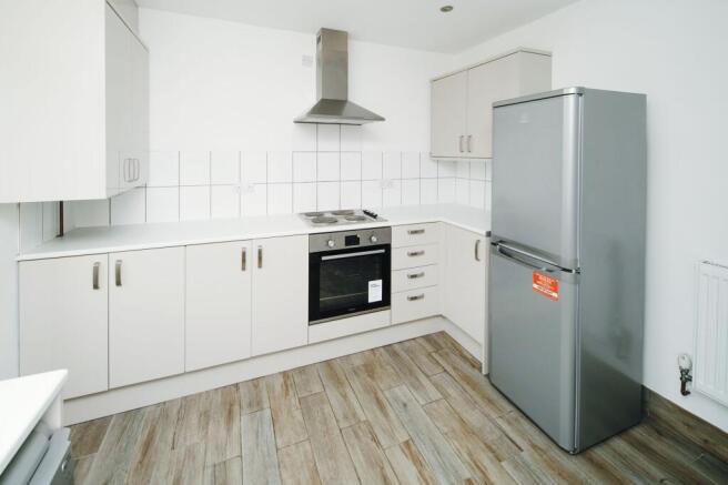 Bright modern kitchen with light cabinetry, int...