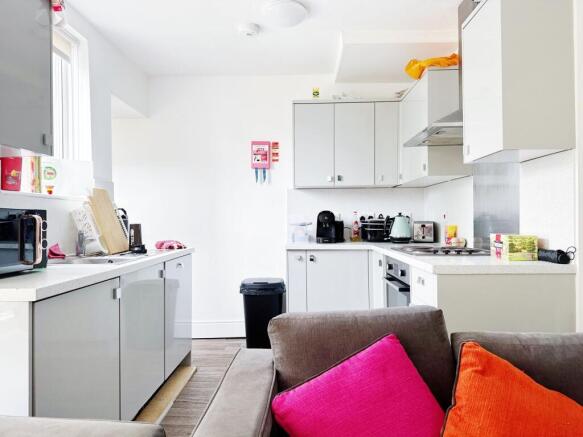 Bright modern kitchen with glossy white cabinet...