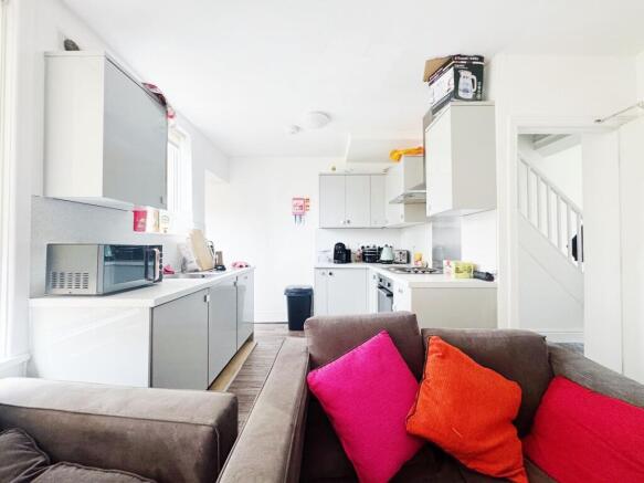 Bright open-plan kitchen and living area with m...