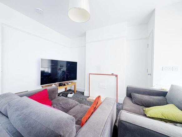 Bright, modern living room with large wall-moun...