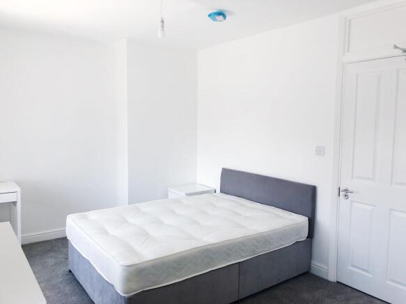 Bright, freshly painted double bedroom with a c...