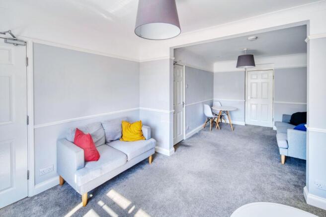 Bright, modern lounge with neutral grey decor, ...