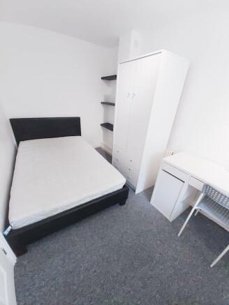 Bright, simply furnished double bedroom with a ...