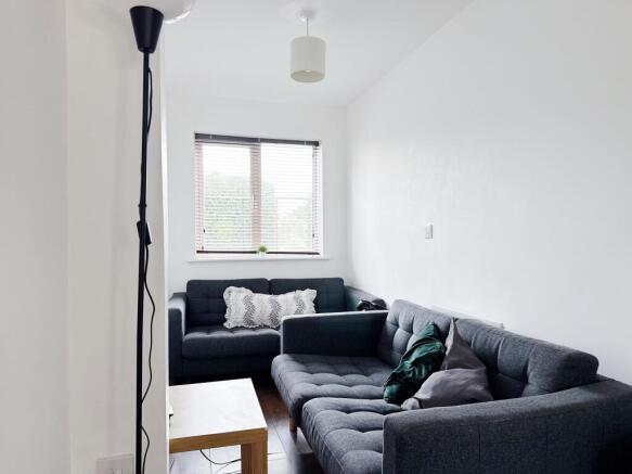 A bright and inviting living room featuring two...