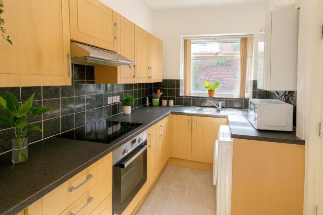 Bright and modern kitchen featuring ample natur...
