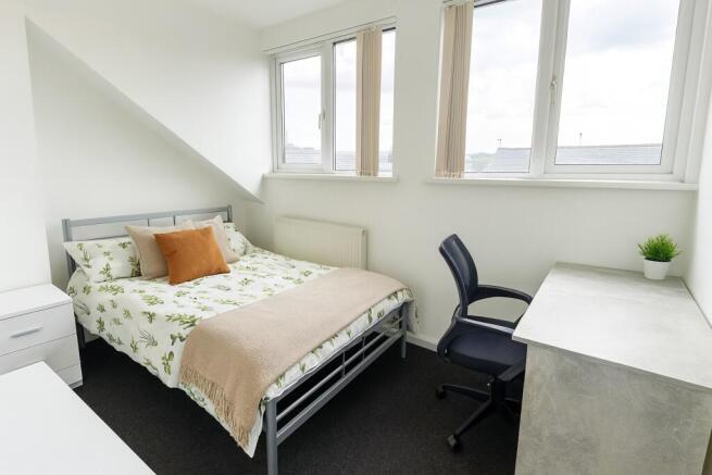 Bright and welcoming bedroom featuring a double...