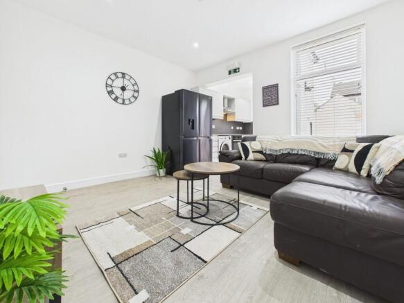 Bright and spacious living room featuring comfo...