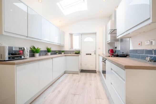 Bright and modern kitchen featuring sleek white...