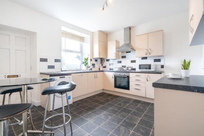 Bright and modern kitchen with ample natural li...