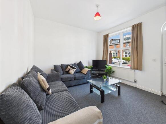 A bright and spacious living room featuring lar...