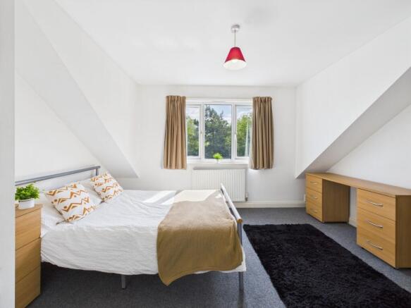 Bright and inviting double bedroom featuring a ...