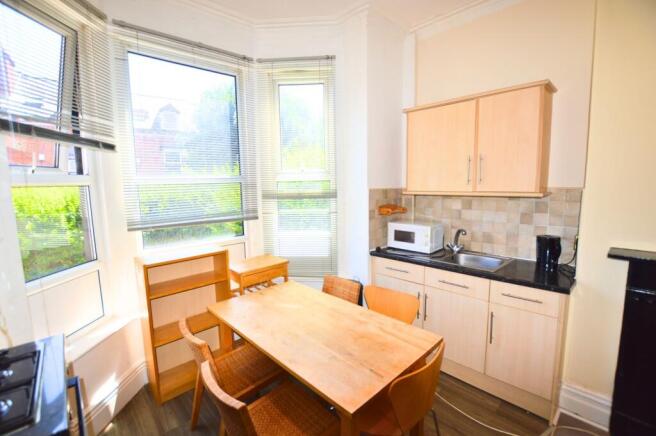 A bright, well-lit kitchen with large windows a...