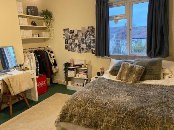 A cozy and stylish double bedroom, featuring am...