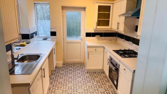 A well-maintained kitted kitchen featuring ampl...