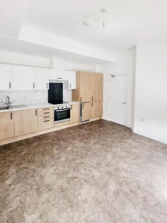 Bright, modern open-plan kitchen with light woo...