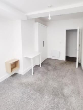 Bright, freshly redecorated bedroom with neutra...