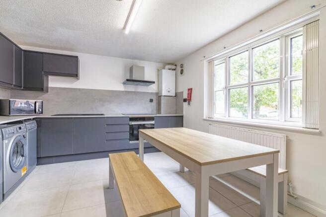 Bright and modern kitchen with large window all...
