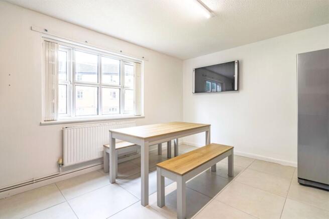A bright and clean kitchen featuring large wind...