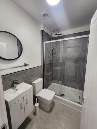 Modern and clean bathroom featuring a shower en...