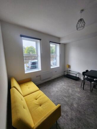 A bright and welcoming living room featuring a ...