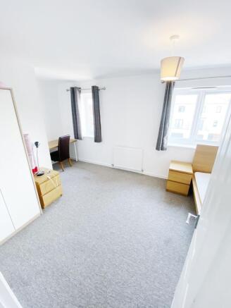 Bright, freshly decorated bedroom with two wind...