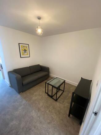 A bright and welcoming living room featuring a ...