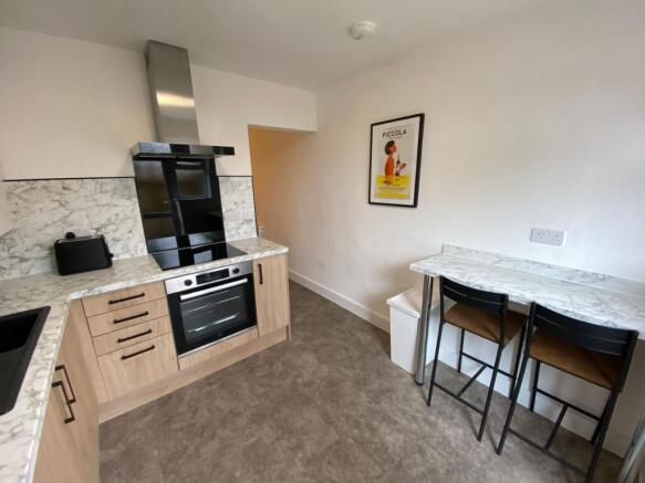 A modern kitchen featuring a marble countertop ...