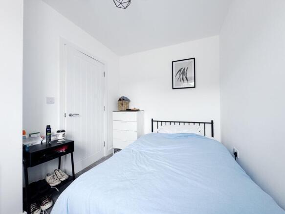 Bright, minimalist single bedroom with crisp wh...