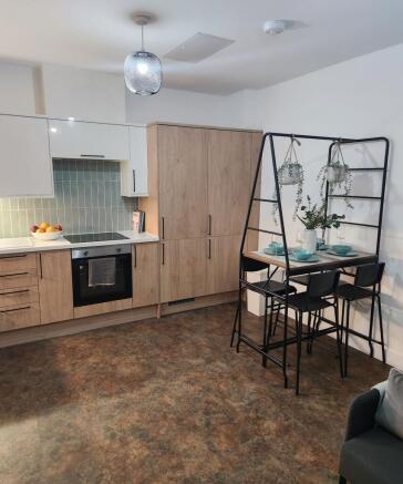 Modern kitchen featuring wooden cabinetry, a bu...