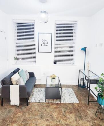 Bright, modern living room with a compact dark ...